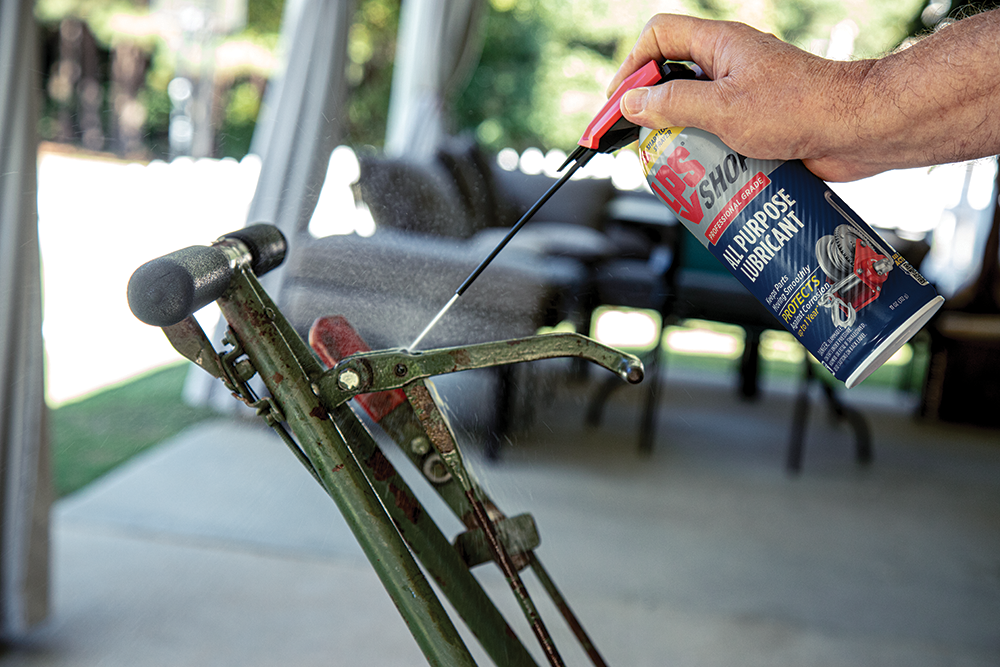 LPS Shop All Purpose Lubricant spraying lawn equipment.