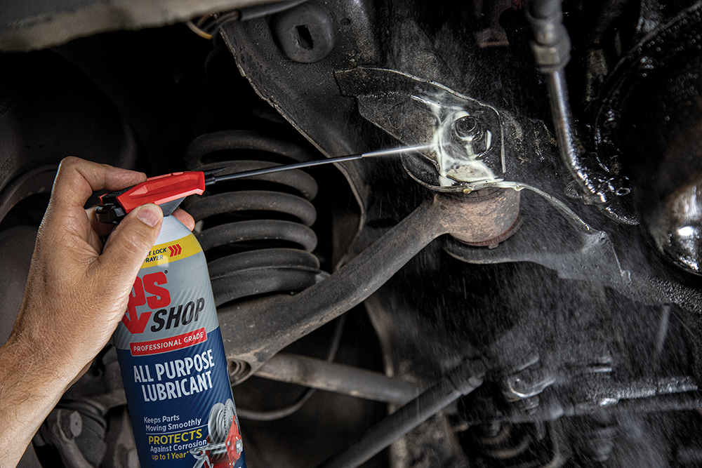 LPS Shop All Purpose Lubricant spraying nut and bolts on a car.