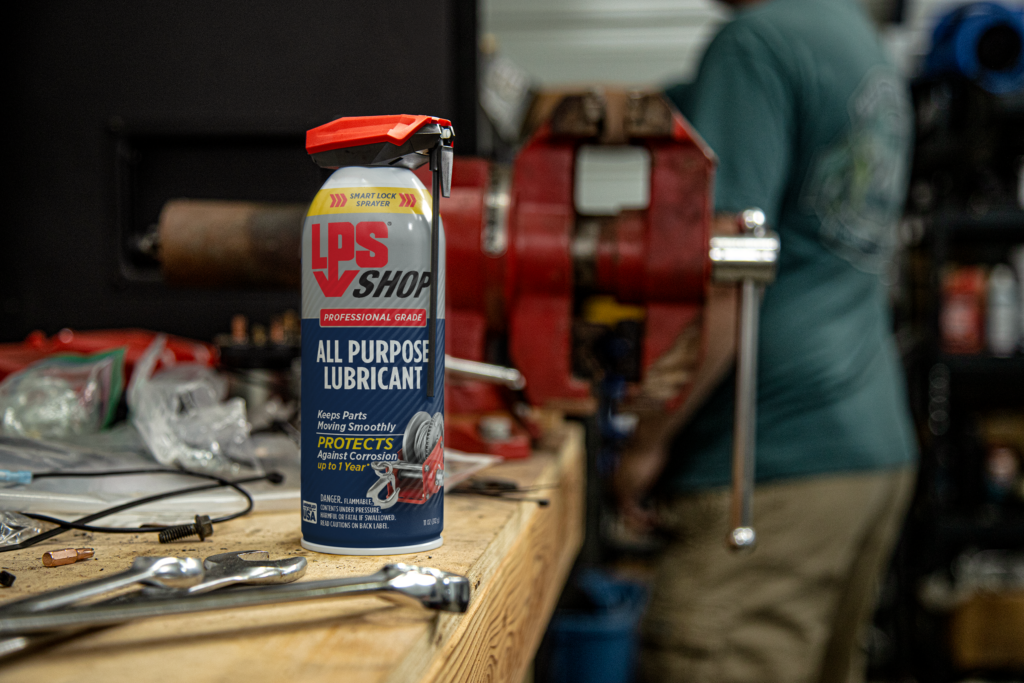 LPS Shop All Purpose Lubricant on a counter in workshop.